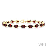 6X4 MM Oval Cut Garnet and 1/6 Ctw Round Cut Diamond Semi-Precious Tennis Bracelet in 10K Yellow Gold