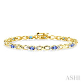 4x3mm Oval Cut Tanzanite and 1/10 Ctw Round Cut Diamond Bracelet in 10K Yellow Gold