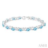 7x5 MM Oval Cut Blue Topaz and 1/20 Ctw Round Cut Diamond Fashion Bracelet in Sterling Silver