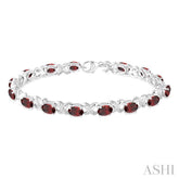 7x5 MM Oval Cut Garnet and 1/20 Ctw Round Cut Diamond Fashion Bracelet in Sterling Silver