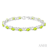 7x5 MM Oval Cut Peridot and 1/20 Ctw Round Cut Diamond Fashion Bracelet in Sterling Silver