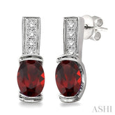 7x5 MM Oval Cut Garnet and 1/50 Ctw Round Cut Diamond Earrings in Sterling Silver