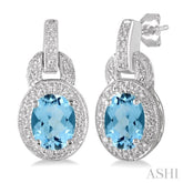 8x6 MM Oval Cut Blue Topaz and 1/20 Ctw Round Cut Diamond Earrings in Sterling Silver