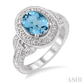 9x7 MM Oval Cut Blue Topaz and 1/20 Ctw Round Cut Diamond Ring in Sterling Silver