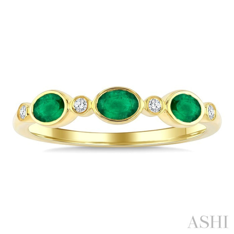 4X3 MM Oval Shape Emerald and 1/20 Ctw Bezel Set Round Cut Diamond Precious Fashion Band in 10K Yellow Gold