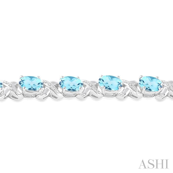 7X5 MM Oval Cut Blue Topaz and 1/20 Ctw Round Cut Diamond Fashion Bracelet in Sterling Silver