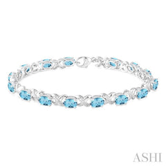 7x5 MM Oval Cut Blue Topaz and 1/20 Ctw Round Cut Diamond Fashion Bracelet in Sterling Silver