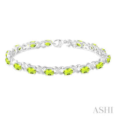 7x5 MM Oval Cut Peridot and 1/20 Ctw Round Cut Diamond Fashion Bracelet in Sterling Silver