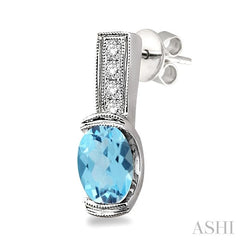 7x5 MM Oval Cut Blue Topaz and 1/50 Ctw Round Cut Diamond Earrings in Sterling Silver