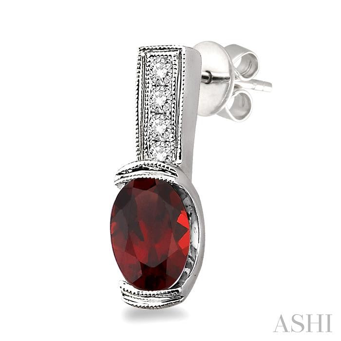 7x5 MM Oval Cut Garnet and 1/50 Ctw Round Cut Diamond Earrings in Sterling Silver