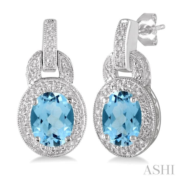 8x6 MM Oval Cut Blue Topaz and 1/20 Ctw Round Cut Diamond Earrings in Sterling Silver