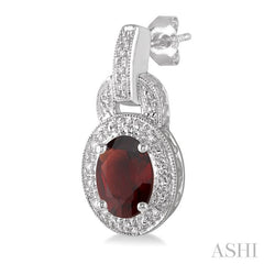 8x6 MM Oval Cut Garnet and 1/20 Ctw Round Cut Diamond Earrings in Sterling Silver