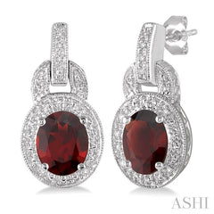 8x6 MM Oval Cut Garnet and 1/20 Ctw Round Cut Diamond Earrings in Sterling Silver