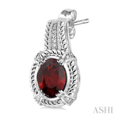 8x6 MM Oval Cut Garnet and 1/20 Ctw Round Cut Diamond Earrings in Sterling Silver