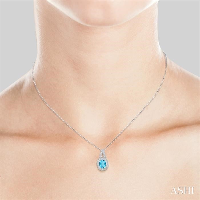 9x7 MM Oval Cut Blue Topaz a and 1/20 Ctw Round Cut Diamond Pendant in Sterling Silver with Chain