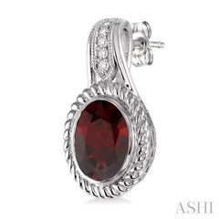9x7 MM Oval Cut Garnet and 1/20 Ctw Round Cut Diamond Earrings in Sterling Silver