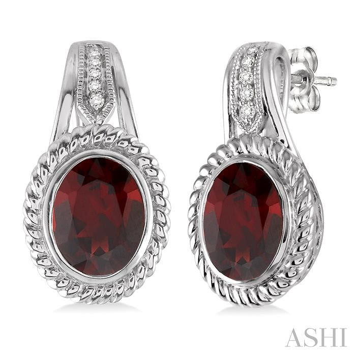 9x7 MM Oval Cut Garnet and 1/20 Ctw Round Cut Diamond Earrings in Sterling Silver